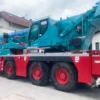 A large crane on the back of a truck.