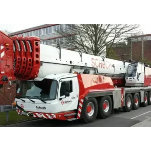 A large crane truck driving down the street.