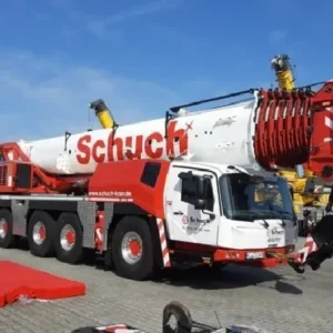 A large crane truck parked on the side of a road.