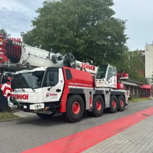 A large crane truck parked on the side of a road.